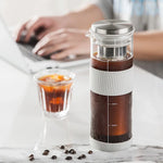 Coffee maker with coffee and glass of iced coffee