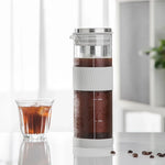Cold brew coffee maker with a glass of iced coffee 