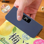 Handheld bag sealer with magnetic strip attached to a refrigerator