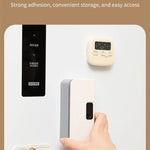 Handheld sealer with magnetic strip attached to a refrigerator