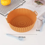 Silicone air fryer liner next to a baking tray showing oven-safe use